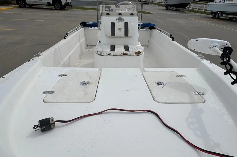 Slide: The Image of 2012 Carolina Skiff 1765 DLX boat interior with storage compartments and seating. - 13