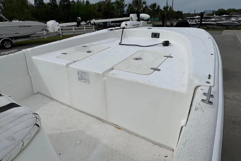 Slide: The Image of 2012 Carolina Skiff 1765 DLX boat deck with storage compartments and seating. - 14