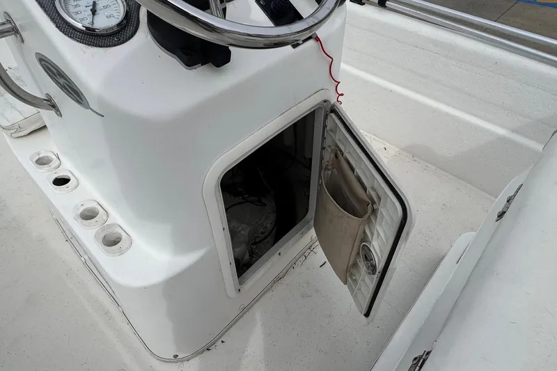Slide: The Image of 2012 Carolina Skiff 1765 DLX boat console with open storage compartment. - 15