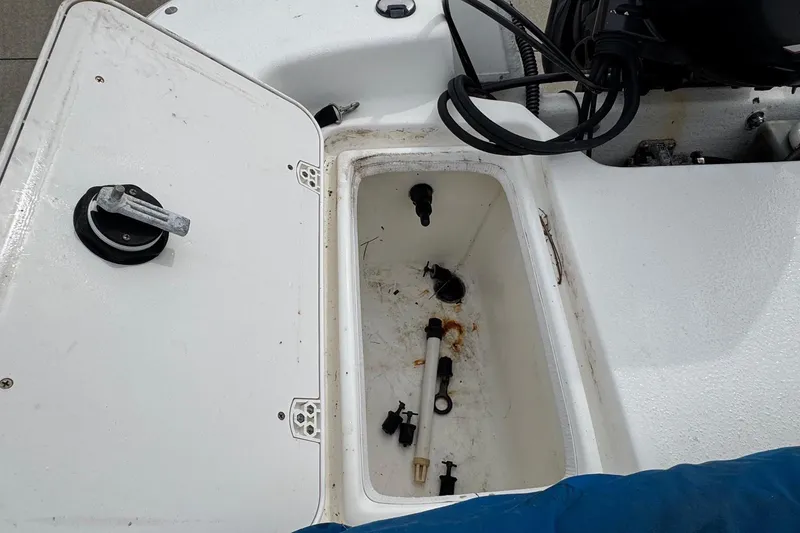 Slide: The Image of Open storage compartment on a 2012 Carolina Skiff 1765 DLX boat, showing interior details. - 16