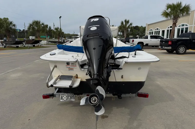 Slide: The Image of 2012 Carolina Skiff 1765 DLX boat with outboard motor on trailer. - 4
