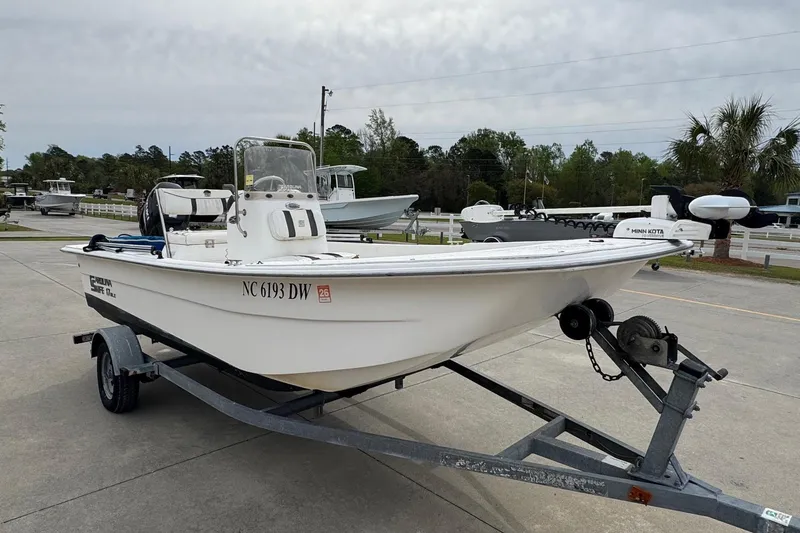 Slide: The Image of 2012 Carolina Skiff 1765 DLX boat on trailer, parked outdoors, ready for transport. - 6
