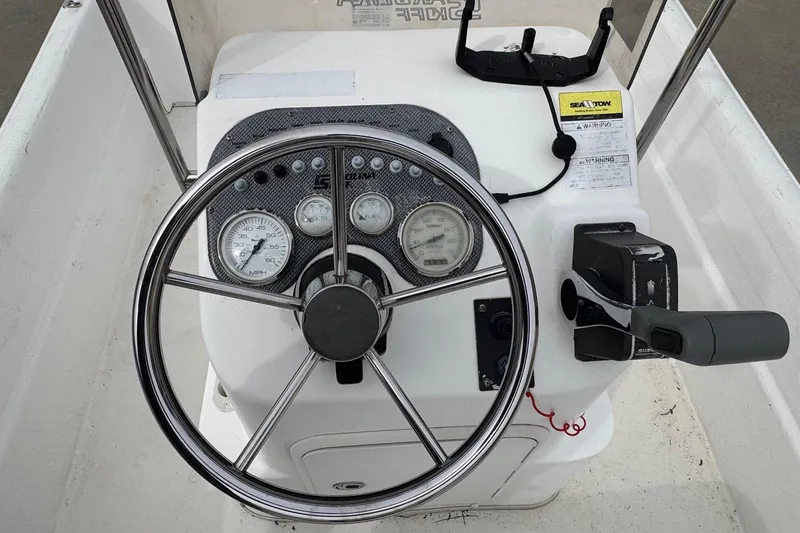 Slide: The Image of Steering console of a 2012 Carolina Skiff 1765 DLX boat with gauges and controls. - 7