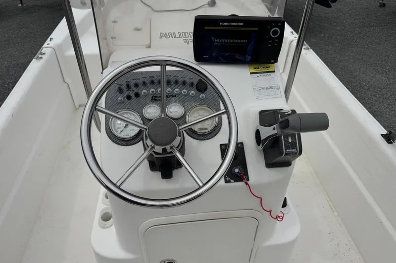 Slide: The Image of Control panel of a 2012 Carolina Skiff 1765 DLX boat with steering wheel and gauges. - 8