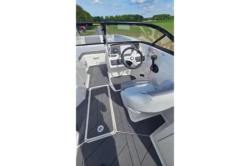 Slide: The Image of 2023 Bayliner DX 2200 boat interior with modern steering and dashboard controls. - 10