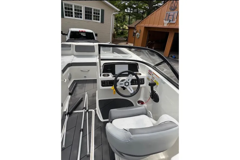 Slide: The Image of 2023 Bayliner DX 2200 boat interior with steering wheel and dashboard controls. - 11