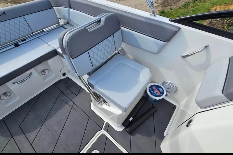 Slide: The Image of 2023 Bayliner DX 2200 boat interior with gray seating and modern design. - 7