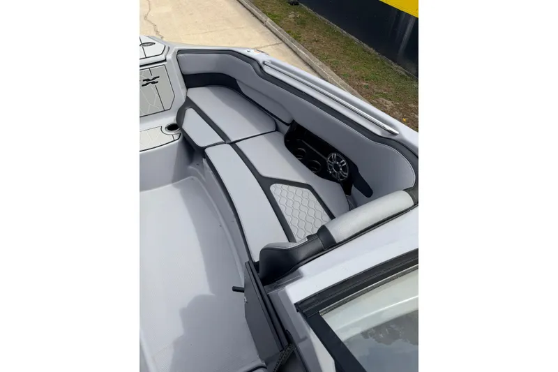 Slide: The Image of 2026 Yamaha Boats 255XD interior seating with sleek gray upholstery and modern design. - 10
