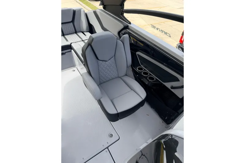 Slide: The Image of 2026 Yamaha Boats 255XD interior with gray seating and cup holders. - 12