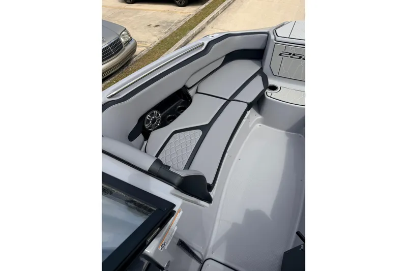Slide: The Image of 2026 Yamaha Boats 255XD interior with sleek gray seating and modern design. - 9