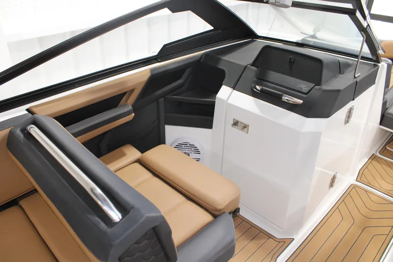 Slide: The Image of 2022 Cobalt R6 Surf boat interior with tan seating and sleek dashboard design. - 10