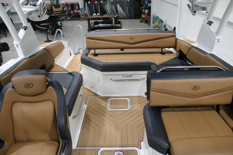 Slide: The Image of 2022 Cobalt R6 Surf boat interior with tan and black seating, showcasing luxury design. - 13