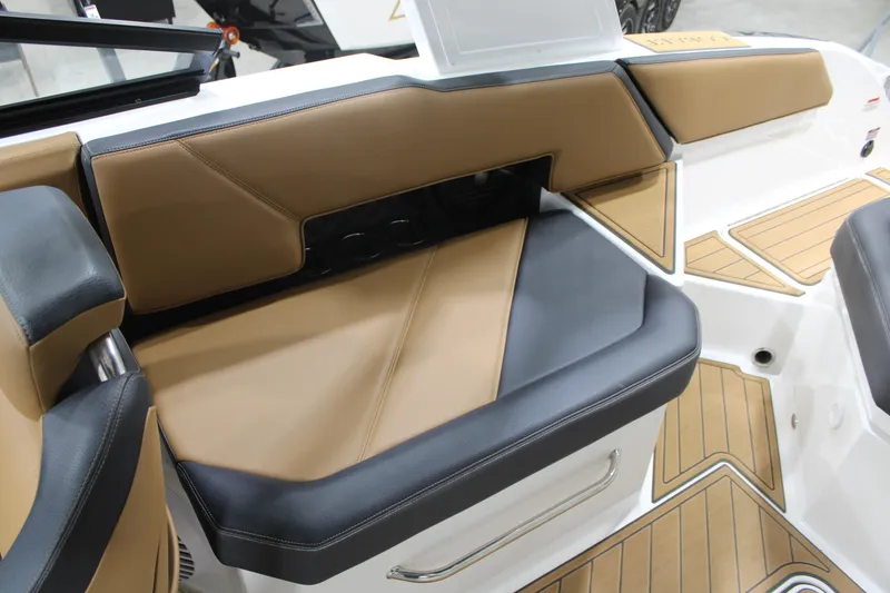 Slide: The Image of 2022 Cobalt R6 Surf boat interior with tan and black seating, showcasing luxury design. - 15