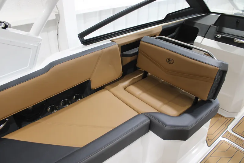 Slide: The Image of 2022 Cobalt R6 Surf boat interior with tan and black seating. - 17