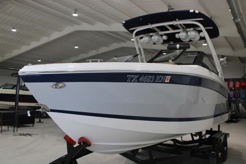 Slide: The Image of 2022 Cobalt R6 Surf boat in showroom, featuring sleek design and modern features. - 2