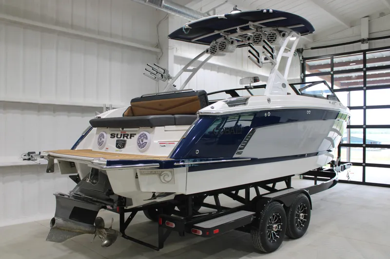 Slide: The Image of 2022 Cobalt R6 Surf boat in showroom, featuring sleek design and modern amenities. - 4