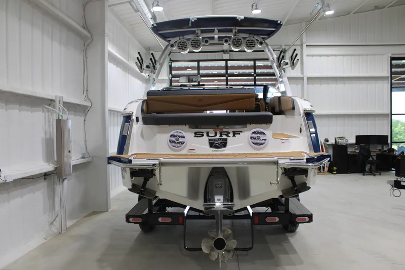 Slide: The Image of 2022 Cobalt R6 Surf boat in a showroom, rear view with surf features. - 5