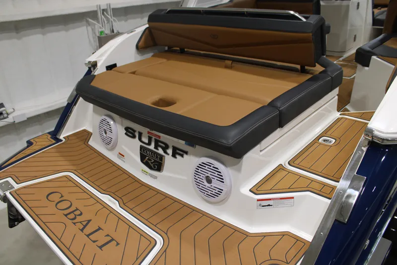 Slide: The Image of 2022 Cobalt R6 Surf boat with tan and black seating, featuring stylish deck design. - 7