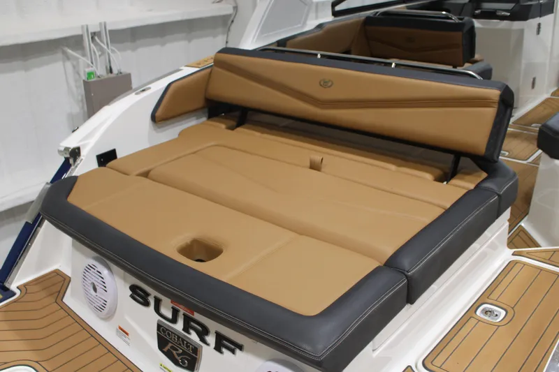 Slide: The Image of 2022 Cobalt R6 Surf boat with tan and black seating, showcasing luxury interior design. - 9