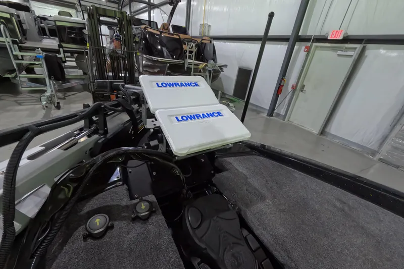 Slide: The Image of 2023 Phoenix 921 Elite boat with Lowrance electronics in a warehouse setting. - 12