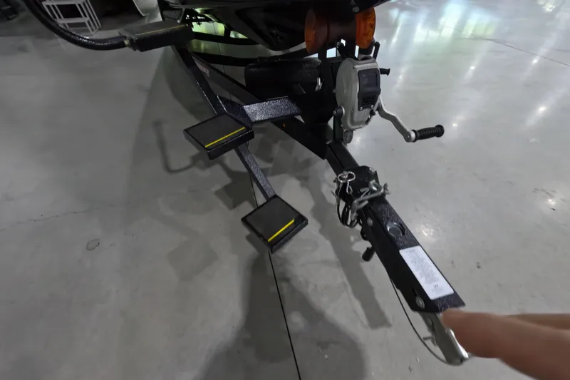 Slide: The Image of Trailer hitch and winch of 2023 Phoenix 921 Elite boat in a showroom. - 14
