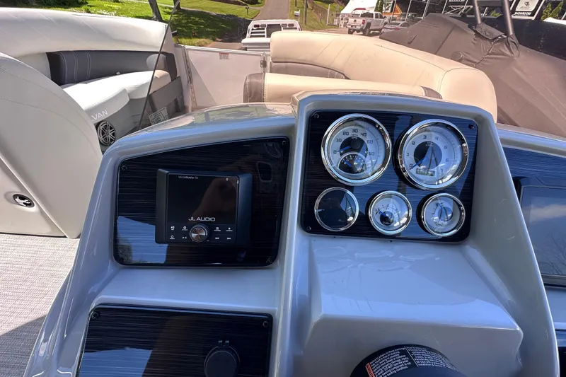 Slide: The Image of Dashboard of 2024 Sylvan Mirage 8522 LZ boat with gauges and audio system. - 13