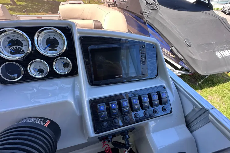 Slide: The Image of 2024 Sylvan Mirage 8522 LZ dashboard with gauges and Garmin display. - 14