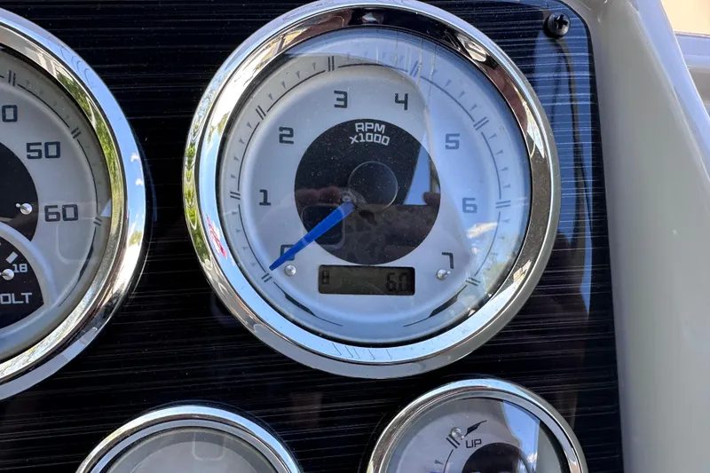 Slide: The Image of Dashboard gauges of 2024 Sylvan Mirage 8522 LZ boat, showing RPM and voltage. - 15