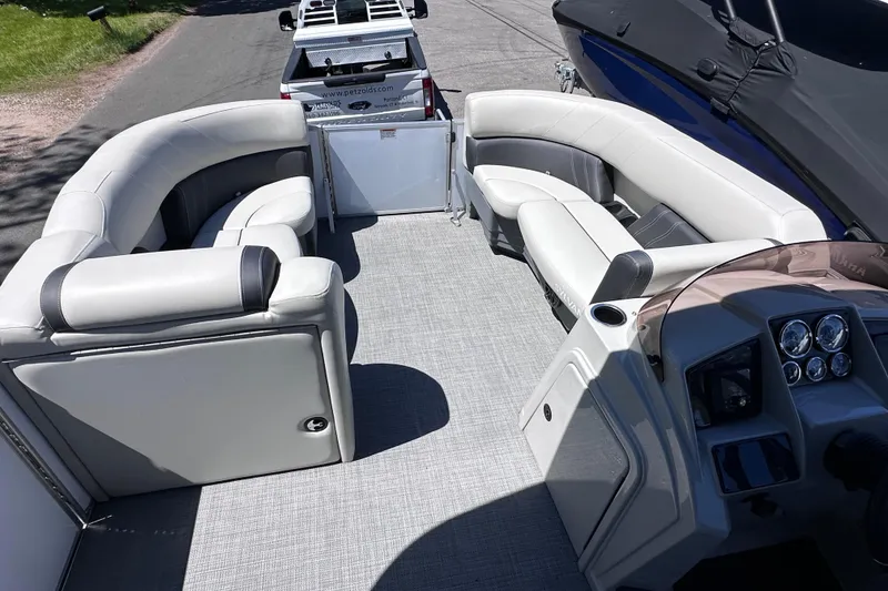 Slide: The Image of 2024 Sylvan Mirage 8522 LZ pontoon boat interior with plush seating and modern dashboard. - 16