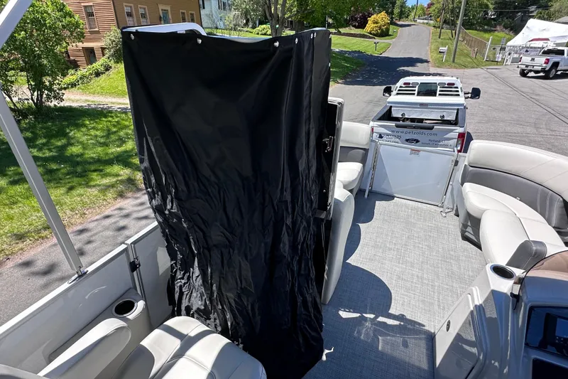 Slide: The Image of 2024 Sylvan Mirage 8522 LZ pontoon boat interior with privacy curtain and seating. - 18
