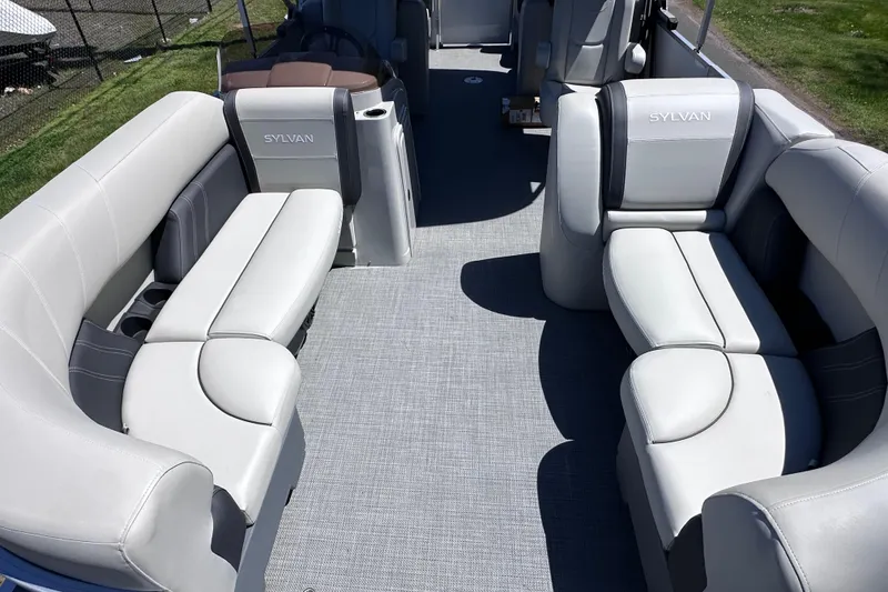 Slide: The Image of 2024 Sylvan Mirage 8522 LZ pontoon boat interior with luxurious seating and modern design. - 23