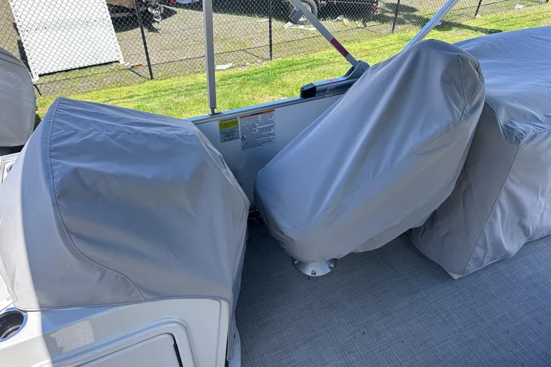Slide: The Image of 2024 Sylvan Mirage 8522 LZ boat seats covered with protective gray fabric. - 26