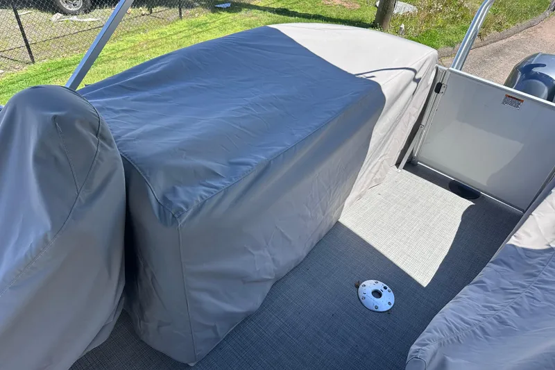 Slide: The Image of 2024 Sylvan Mirage 8522 LZ boat interior with protective covers on seats. - 27