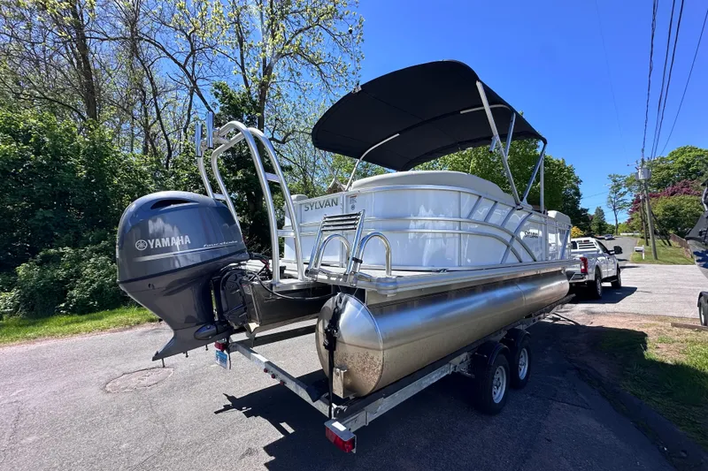 Slide: The Image of 2024 Sylvan Mirage 8522 LZ pontoon boat with Yamaha engine on trailer. - 5