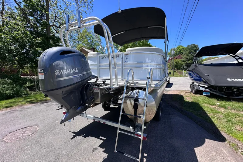 Slide: The Image of 2024 Sylvan Mirage 8522 LZ pontoon boat with Yamaha outboard motor, parked outdoors. - 6