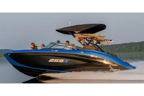 Slide: The Image of 2026 Yamaha Boats 255XD speeding on a lake with passengers and wakeboards. - 11