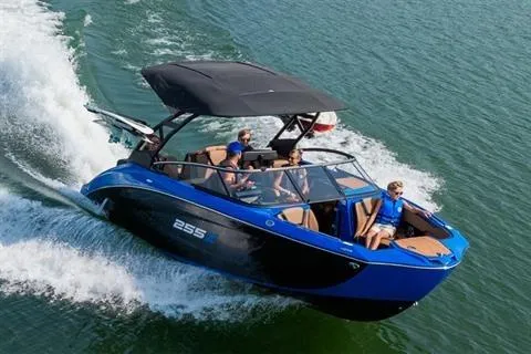 Slide: The Image of 2026 Yamaha Boats 255XD cruising on water with passengers, featuring sleek design and blue accents. - 12