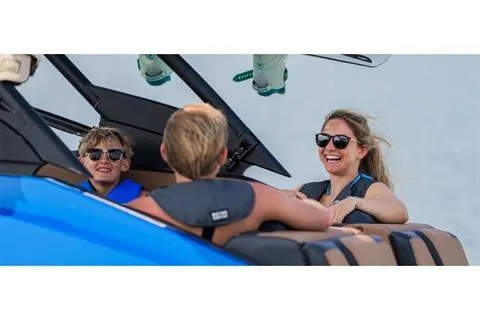 Slide: The Image of Family enjoying a ride on a 2026 Yamaha Boats 255XD, smiling and wearing sunglasses. - 15