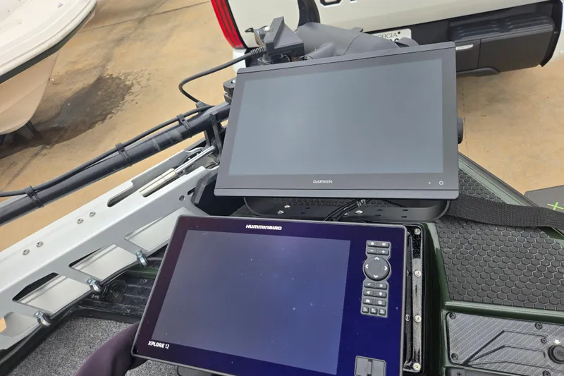 Slide: The Image of Dual marine navigation screens on a 2026 Phoenix 921 Elite X boat dashboard. - 10