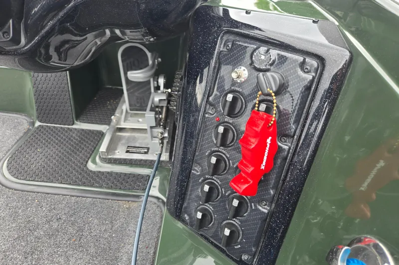 Slide: The Image of Control panel of 2026 Phoenix 921 Elite X boat with switches and safety key. - 12