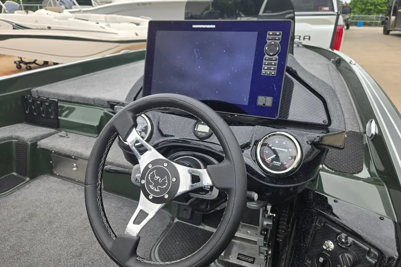 Slide: The Image of 2026 Phoenix 921 Elite X boat dashboard with steering wheel and navigation display. - 13