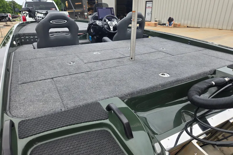 Slide: The Image of 2026 Phoenix 921 Elite X boat interior with gray carpet and dual seats. - 17