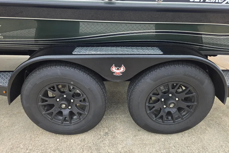 Slide: The Image of 2026 Phoenix 921 Elite X trailer with black wheels and distinctive logo design. - 18