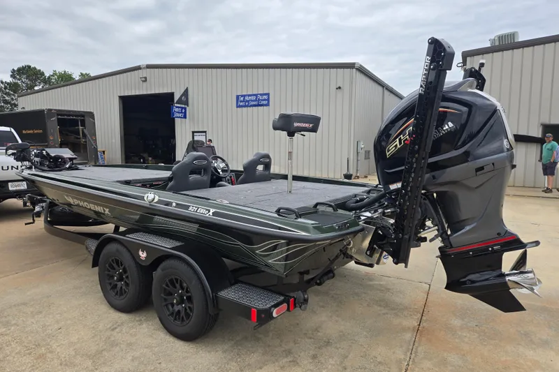 Slide: The Image of 2026 Phoenix 921 Elite X boat with Yamaha engine, parked outside service center. - 5