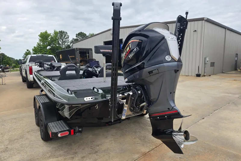 Slide: The Image of 2026 Phoenix 921 Elite X boat with Yamaha engine, parked on a trailer outside a warehouse. - 6
