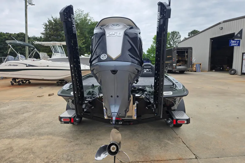 Slide: The Image of 2026 Phoenix 921 Elite X boat with powerful engine, parked near service area. - 7