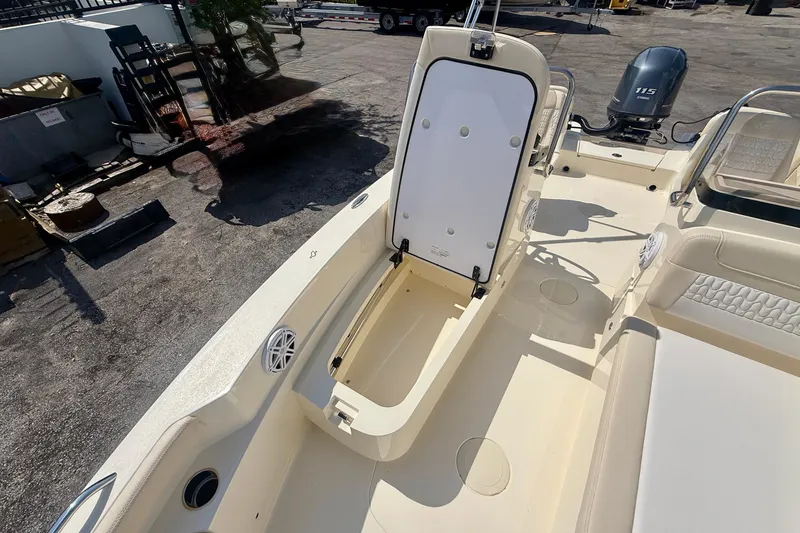 Slide: The Image of 2026 Scout 188 Sport Dorado boat interior with open storage compartment and Yamaha 115 engine. - 12