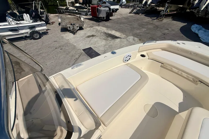 Slide: The Image of 2026 Scout 188 Sport Dorado boat interior with beige seating and docked boats in background. - 15