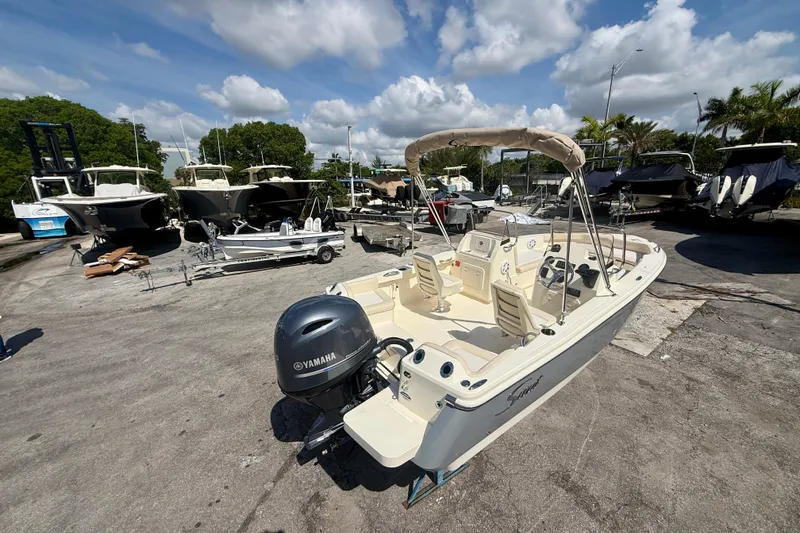 Slide: The Image of 2026 Scout 188 Sport Dorado boat with Yamaha engine in a marina setting. - 3