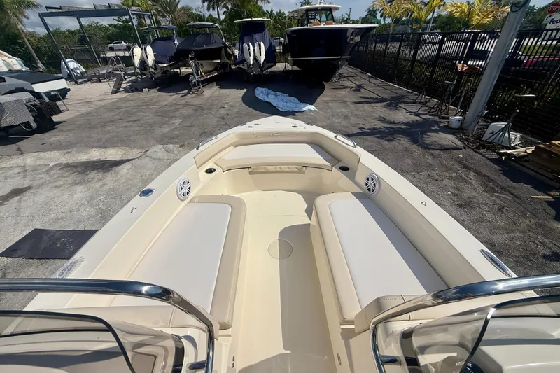 Slide: The Image of 2026 Scout 188 Sport Dorado boat interior with seating, docked outdoors. - 9